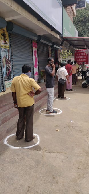 Customers queue up with adequate distance between them as they approach a store in Tamil Nadu, India
