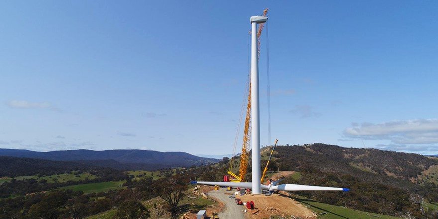 The first turbine nears completion with the blades and hub (the rotor) being assembled. 26 of the 39 wind turbine foundations have also been poured.